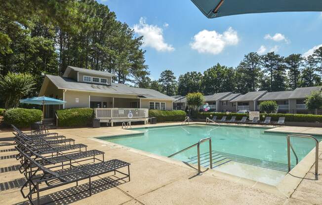 Daytime view pool with patio at Harvard Place Apartment Homes by ICER, Lithonia, GA