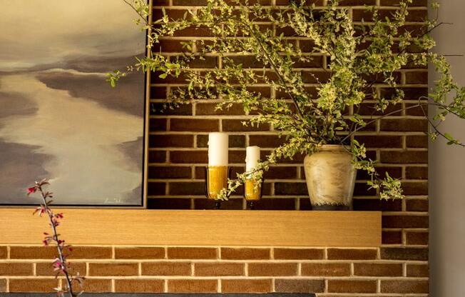 a brick fireplace with a plant on top of it