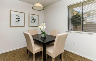 a room filled with furniture and vase of flowers on a table