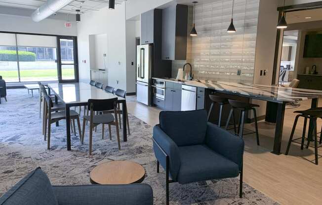 community room with lounge seating and kitchen at Haven at Uptown in Lincoln, NE