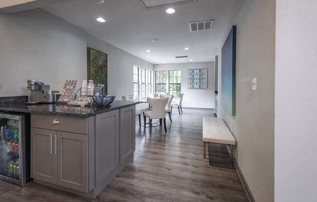 a coffee station with a counter and a seating area in the background