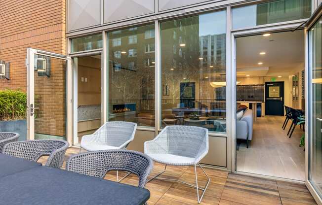 a patio with chairs and a table and sliding glass doors