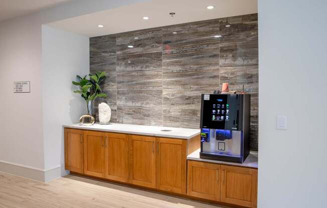 A modern kitchen with wooden cabinets and a stone backsplash.