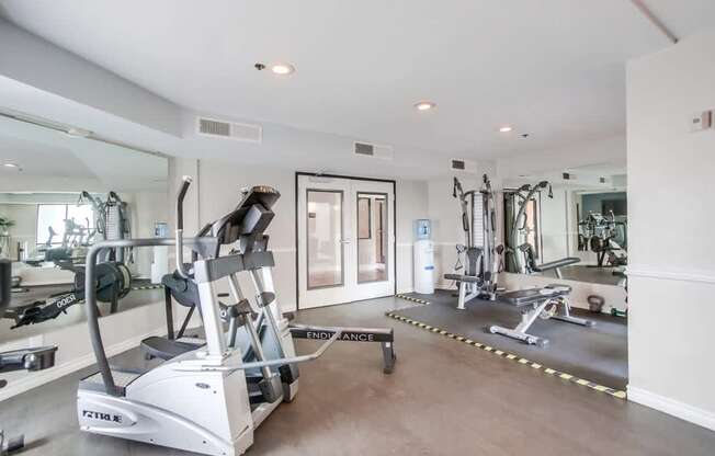 A gym with a treadmill and other exercise equipment.