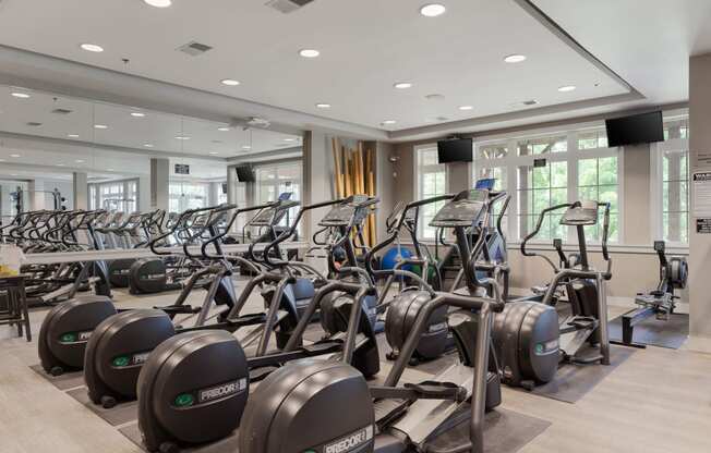 a gym filled with cardio machines and weights