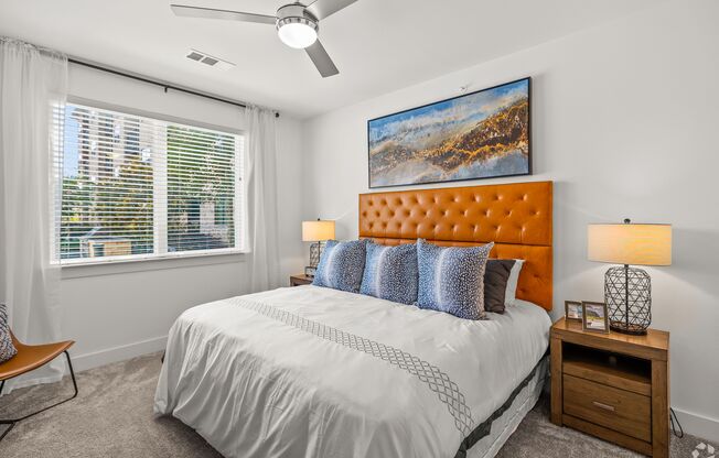 A bedroom with a large bed, a ceiling fan, and a painting on the wall. at Aurora Watson Branch, Texas, 76063
