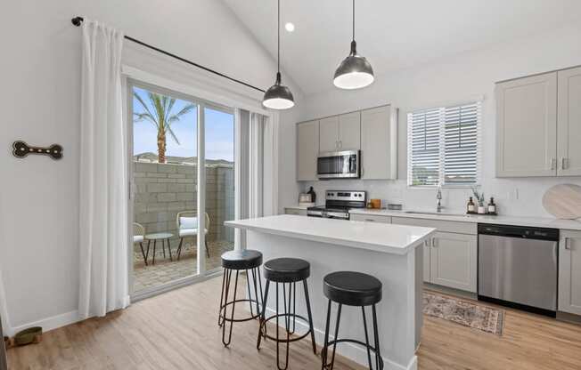 an open kitchen with a island and three stools