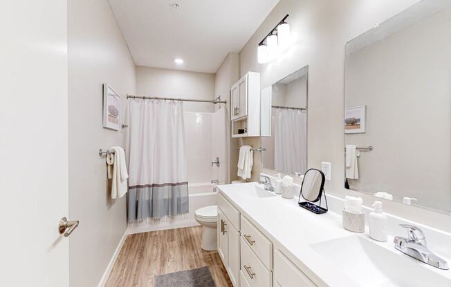 a bathroom with a shower toilet and sink