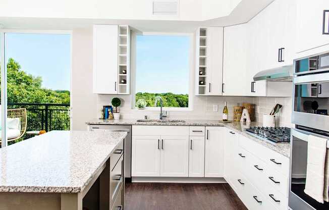 Modern kitchen with sleek stainless steel appliances, granite countertops, a built-in dishwasher, and a stylish gas range. Minnetonka, MN.