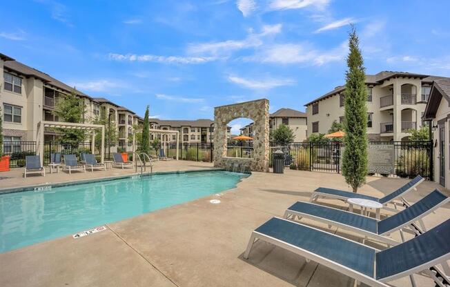 a resort style pool with lounge chairs at Palisades at Pleasant Crossing, Arkansas