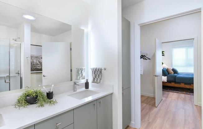 Featuring sleek quartz countertops and elegant front-lit mirrors, these spaces offer a perfect blend of style and function.