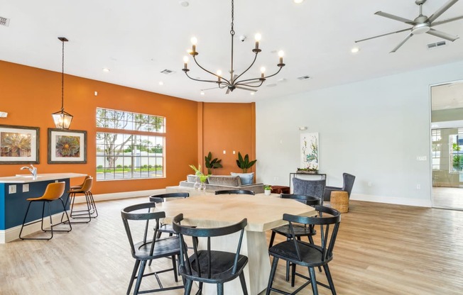 a club room with a large table and chairs at Reserve at Temple Terrace, Temple Terrace