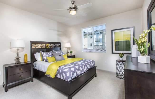 1 BR Apartments in Chino Hills, CA - Capriana at Chino Hills - Bedroom with Plush Carpeting and a Ceiling Fan at Capriana at Chino Hills, Chino Hills