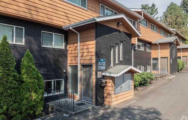 A building with a brown and black exterior and a sign that reads "2412 788".