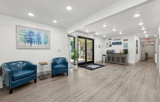 A leasing office with a coffee bar and chairs at Gwinnett Square Apartments in Duluth, GA