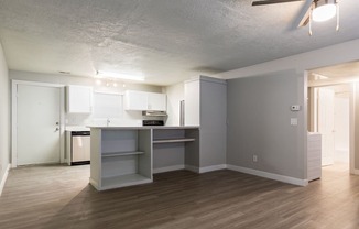 A kitchen with a white counter top and a white fridge.