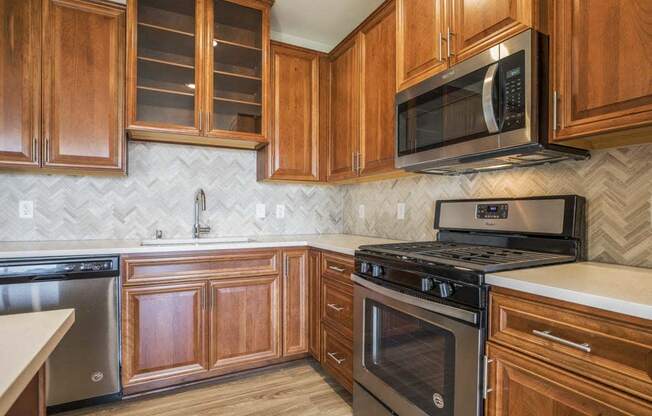 Premium design scheme with custom cabinetry and herringbone backsplash at Ascend at Woodbury MN 55129 new luxury apartments