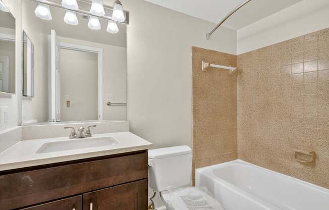 A bathroom with a white sink and a white toilet.
