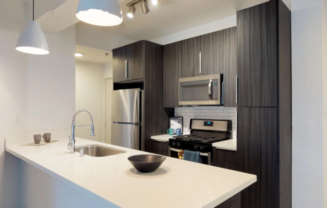 Modern kitchen featuring dual tone cabinetry and large island