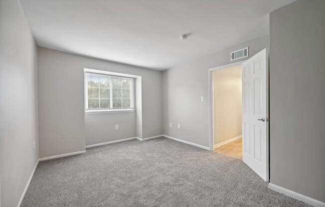 an empty room with a white door and a window at ReNew Odenton
