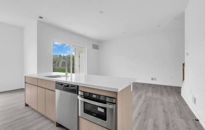 A modern kitchen with a stainless steel dishwasher and oven. at The Franklin Marlboro Apartments, New Jersey, 07746