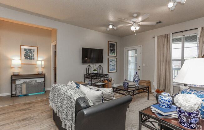 a living room with a couch and a ceiling fan