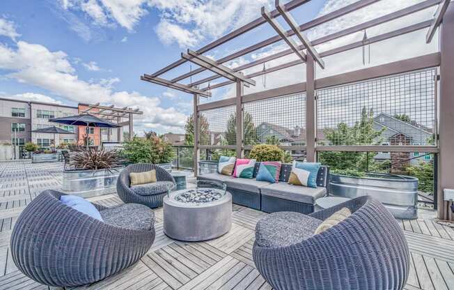 Outdoor patio with wicker furniture and a firepit at Platform 14, Hillsboro, OR