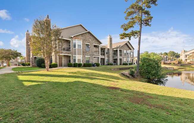 A large house with a green lawn in front.