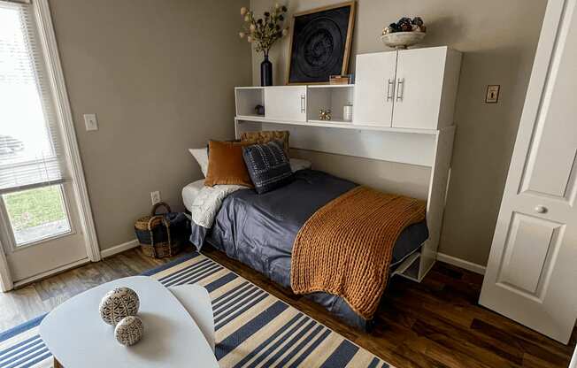 a bedroom with a bed and a table in the corner