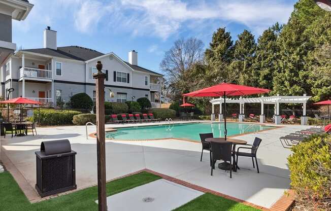 Community clubhouse and pool area with loungers and tables