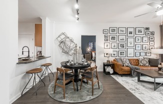 a dining area with a round table and four chairs