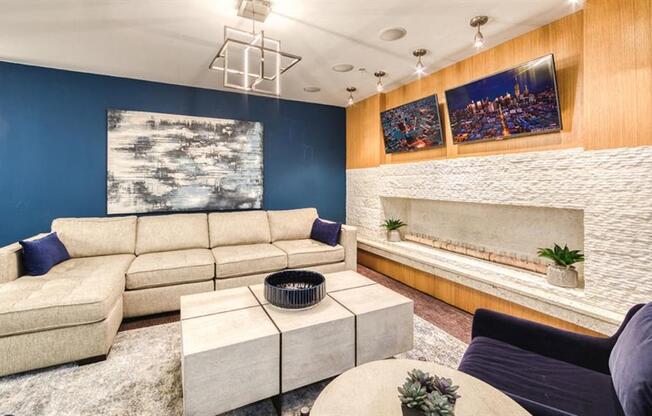 A modern living room with a large sectional sofa and a coffee table.