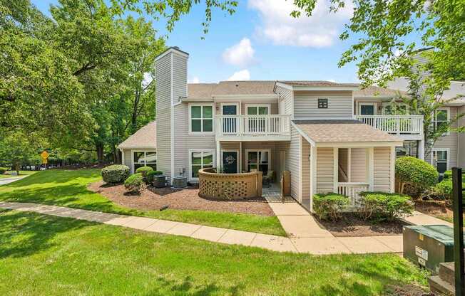 A house with a well-maintained lawn and a clear sky.