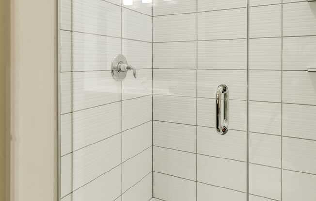 Shower with subway tile and glass doors at Ascend at Woodbury in MN