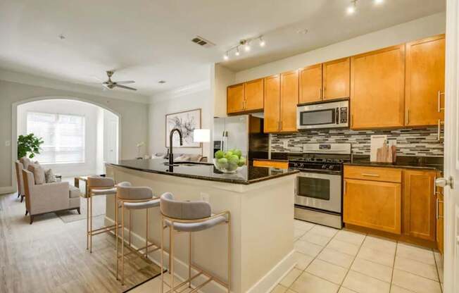A kitchen with a bar area and a dining area.