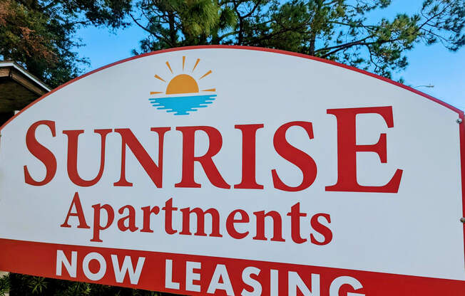 a sign that reads sunrise apartments now leasing