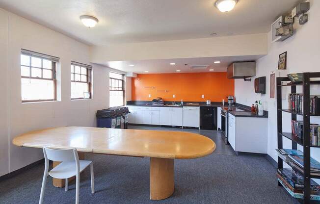 a room with a table and chairs and a kitchen in the background at MILEPOST 5 Apartments, PORTLAND, 97213