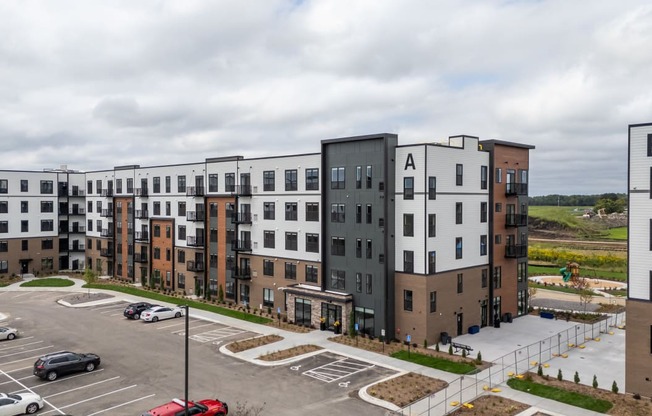 an aerial view of an apartment complex in a parking lot at The Edison at Maple Grove, Minnesota