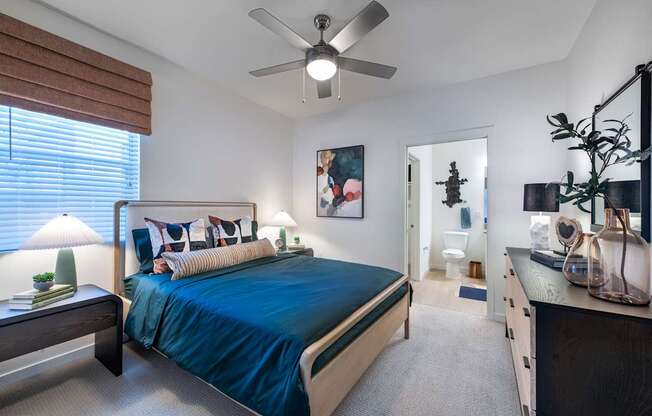 a bedroom with a bed and a ceiling fan