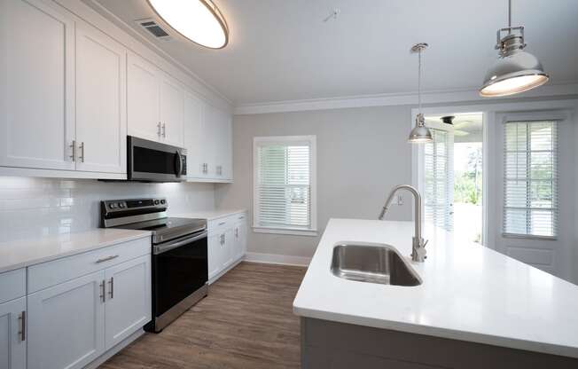 a kitchen with white cabinets and a white counter top