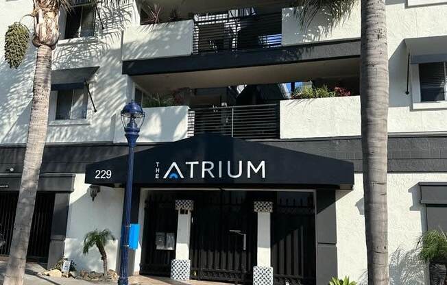 Sidewalk view of front enterance at the Atrium Apartments in downtown San Diego, CA.