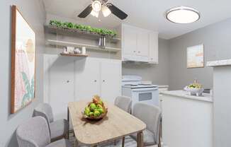 A kitchen with a table and chairs and a bowl of fruit on the table.