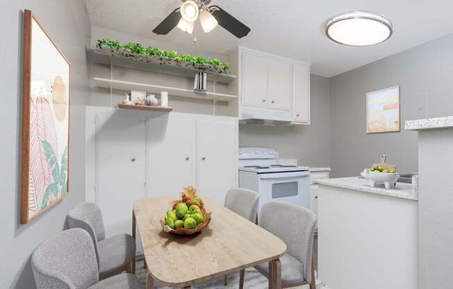 A kitchen with a table and chairs and a bowl of fruit on the table.
