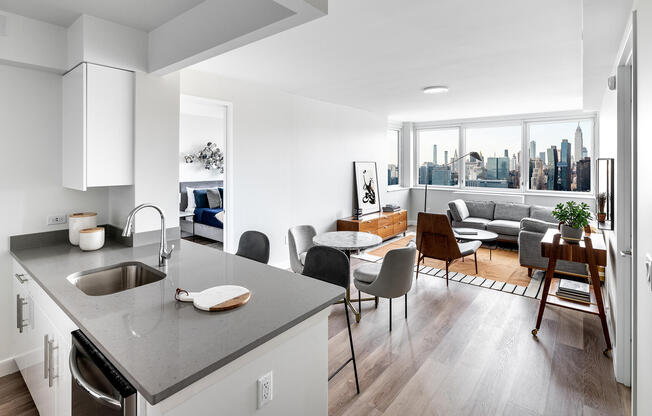 Open kitchen and living room with triple exposure and direct Manhattan skyline views. Apartment 3011