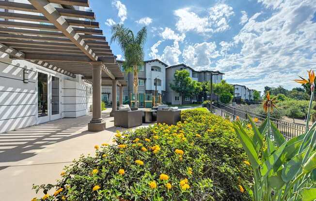 A sunny day at a residential area with apartment buildings and a fence.