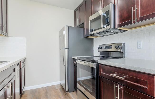 a kitchen with stainless steel appliances and wooden cabinets