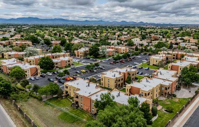 A view of a town with buildings and cars from a high vantage point.