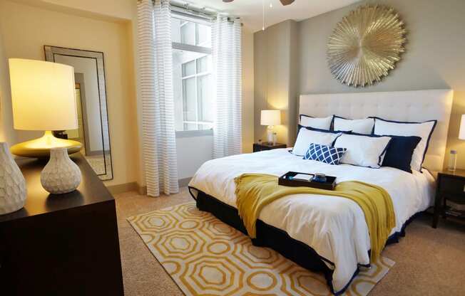 a bedroom with a white bed and yellow blanket