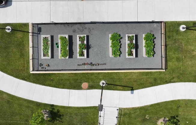 an aerial view of a parking lot with grass and trees