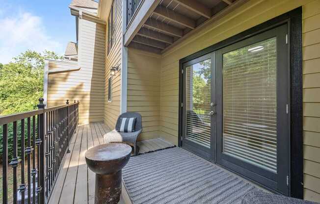 A balcony with a bench and a black railing.